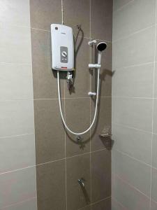 a shower in a bathroom with a soap dispenser at P3 Great value, cozy, convenient in city! in Kuching
