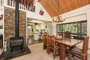 a kitchen and dining room with a wood stove at 235 Verde Lane Hideaway River Cabin in Vallecito