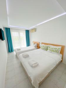 Postel nebo postele na pokoji v ubytování Mercan Otel