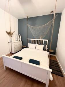 a bedroom with a swinging bed with a net at Sailor Apartment by Marina Old Town for 8 people, free parking! in Gdańsk