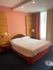 a hotel room with a large bed and a window at Eventhaus in Panzweiler