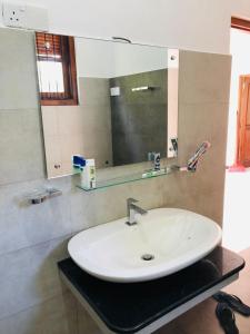 a bathroom with a white sink and a mirror at Bluminz Homes in Katugastota