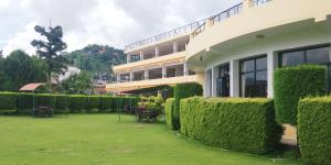 a building with a yard with chairs and tables at Hotel Mystic Buddha in Kathmandu