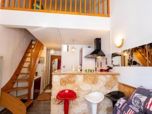 a kitchen with a staircase and a living room at Appartement Valfréjus, 2 pièces, 4 personnes - FR-1-468-107 in Modane