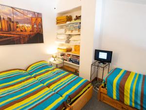 a bedroom with two beds and a television in it at Appartement Valfréjus, 2 pièces, 4 personnes - FR-1-468-107 in Modane