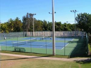 a tennis court with two tennis courts at Dulce Limón - Costa Campo in Cabo Rojo