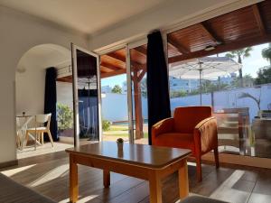 a living room with a table and a chair at Bungalows Teresa in Playa del Ingles