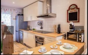 a kitchen with a table with cups and plates on it at Islantilla golf playa in Huelva