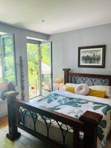 ein Schlafzimmer mit einem großen Bett und einem Fenster in der Unterkunft Les Hiboux in Crozant