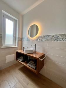 a bathroom with a sink and a mirror at Le Gorgoni Tropea b&b in Tropea +7 photos