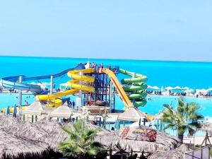 a roller coaster in the water at a resort at شاليه ٢٩ لا ارضي غرفتين اللوتس الساحل الشمالى in El Alamein