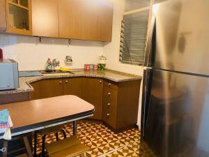 a kitchen with a stainless steel refrigerator and a table at Good apartment 2 bedroom in Bat Yam