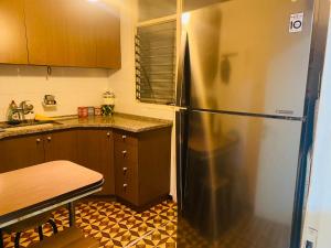 a kitchen with a refrigerator and a table in it at Good apartment 2 bedroom in Bat Yam