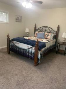 a bedroom with a bed with a wooden frame at Cute house in quiet neighborhood in Saginaw