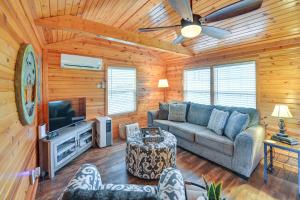 a living room with a couch and a tv at Our Lakeside Retreat with Deck on Lake Herrington! in Bushtown