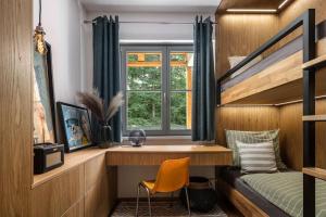 1 dormitorio con litera, escritorio y ventana en Luxury 2 Bedroom Mountain Escape, en Harrachov