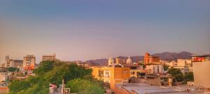 a city with buildings and mountains in the background at Fatima Hostel Santa Marta in Santa Marta