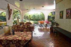 a living room with a table and chairs in a room at Casa Joaquin BnB in Manila