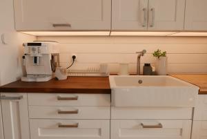 a kitchen with a sink and a coffee maker at Villa Jacqueline, la baie du Mont-Saint-Michel in Dragey +66 photos