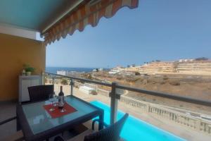 Un balcón con mesa y vista al mar. en Apartment with view, wifi and pool in Arguineguin, en Arguineguín