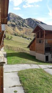 a view of a building with a mountain in the background at APPARTEMENT PIEDS DE PISTE - 4-6 PERSONNES in La Chal