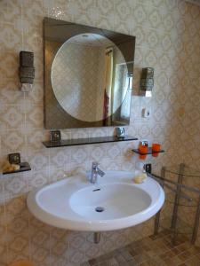 a bathroom with a sink and a mirror at Haus Kröll in Mittersill