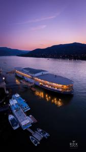 a large boat is docked in the water at Aquamarina Hotel Visegrád in Visegrád