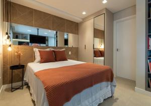 a bedroom with a large bed and a large mirror at Charming Studio - Guarulhos, near the GRU Airport in Guarulhos