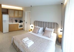 a bedroom with a large bed with pillows on it at Paligremnos Infinity in Plakias
