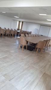 a conference room with a wooden table and chairs at Hotel Konstantin in Prishtinë