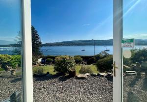a door leading to a view of the water at Ardmun House in Dunoon
