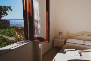 Postel nebo postele na pokoji v ubytování Le terrazze sullo Stagnone