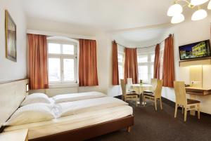 Postel nebo postele na pokoji v ubytování Hotel Goldene Krone Innsbruck