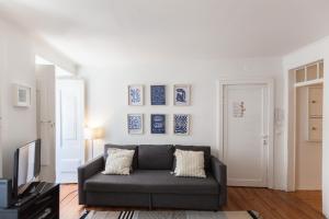 a living room with a couch and blue and white walls at FLH - Central Flat in Bairro Alto in Lisbon