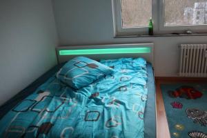 a bedroom with a bed with a blue comforter at 2 Zimmer Wohnung zum Auspowern oder Erholen. in Erkrath