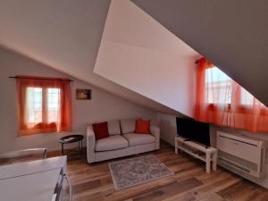a living room with a couch and a tv at enJoy Home - Mansarda Piccolo Tesoro in Padova