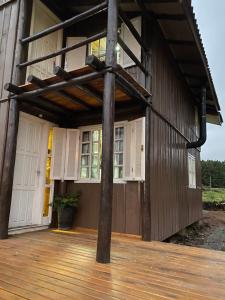 a porch of a house with a wooden deck at Morada das Estrelas in Cambara do Sul