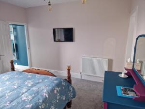 a bedroom with a bed and a blue table at Fylde Court in Morecambe