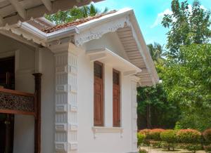Casa blanca con ventana y techo en Andiramada Walawwa en Rambukkana