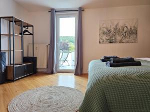 a bedroom with two beds and a large window at Ara - Loft, Big Terrace, BBQ, Tischkicker, PS4, Stream in Marburg an der Lahn +20 photos