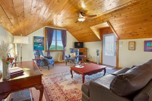 a living room with a couch and a wooden ceiling at Swing On Inn- Southern Comfort in Dripping Springs