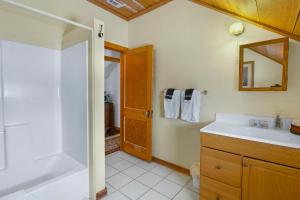 a bathroom with a tub and a sink and a shower at Swing On Inn- Southern Comfort in Dripping Springs