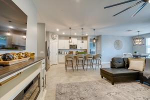 a living room and kitchen with a couch and a table at Buckeye Verrado Area Home with Pergola and Fire Pit in Litchfield Park
