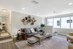 a living room with a couch and a table at New 2BR Bungalow Apartment #5 in West Palm Beach