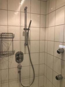 a shower with a hose in a bathroom at Lochau Sonnenuntergang genießen in Lochau
