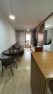 a living room with a table and a couch at Flat beira lago no centro de BSB in Brasilia