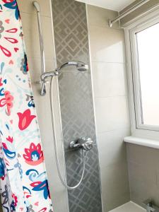 a shower in a bathroom with a shower curtain at De Montfort House in London