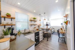a kitchen and living room with a table and chairs at New Luxury Shipping Container in Bellmead