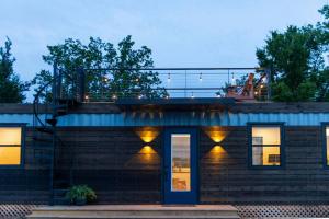 a house with lights on the side of it at New Luxury Shipping Container in Bellmead