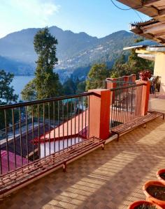 een balkon met uitzicht op de bergen bij Sukoon- A Lake view BnB in Nainital